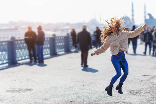 istock Happy jumping girl on the bridge 1139020844