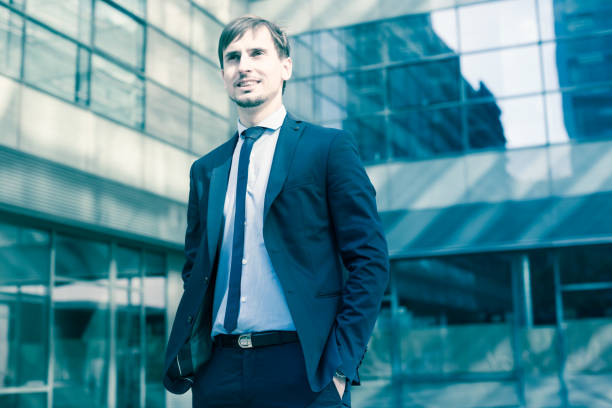 istock Smiling businessman standing outdoors 1139022463