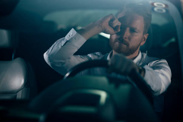 istock Sleepy businessman driving car 1139022642