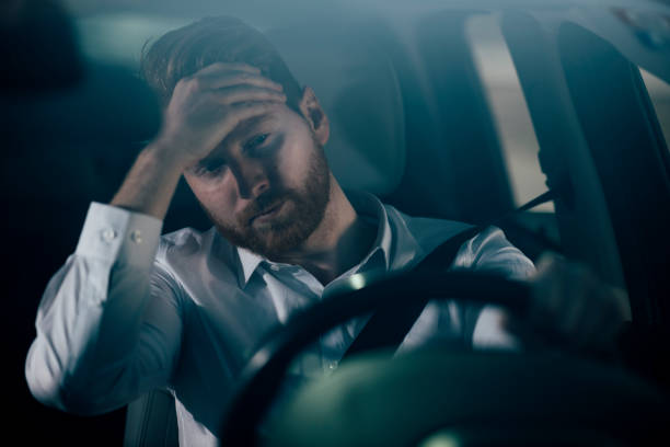 istock Sleepy businessman driving car 1139022753