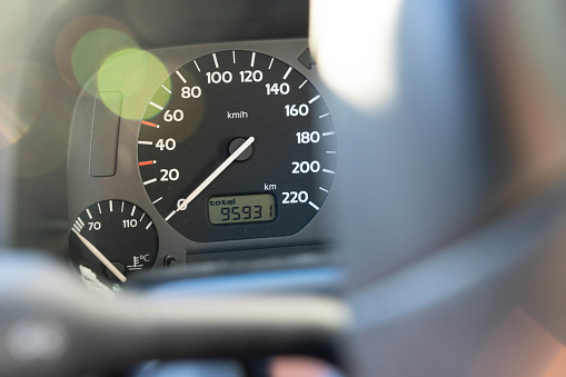 Tachometer of a car seen through a steering wheel