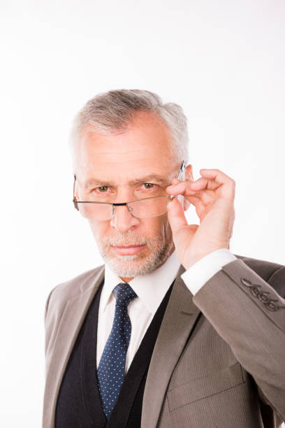 istock Old businessman in an elegant suit with glasses 1139028451