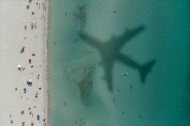 istock shadow of a plane flying over the beach 1139032368