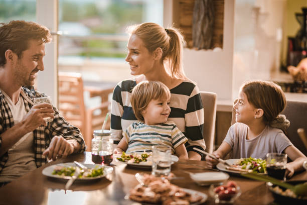 istock Happy family communicating during lunch time in dining room. 1139033257
