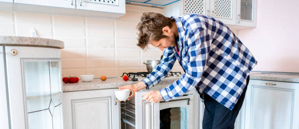 istock young man taking some things in the kithcen while cooking at home f 1139034424