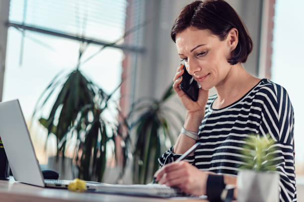 istock Woman talking on the smart phone in the office 1139034543