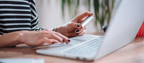 istock Woman shopping online and using credit card 1139034618