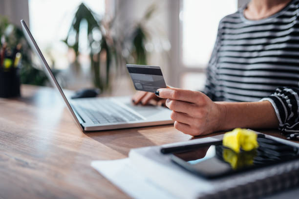 istock Woman shopping online and using credit card 1139035667