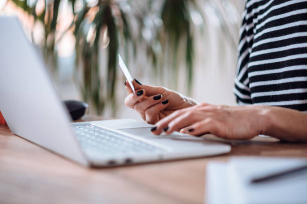 istock Woman shopping online and using credit card 1139035816