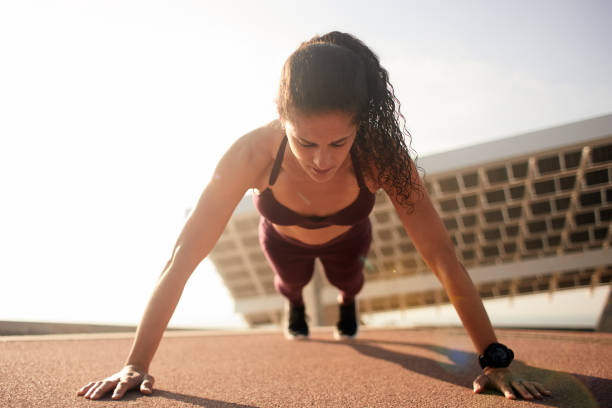 istock One woman running and exercising and doing push-ups in Barcelona. 1139036081