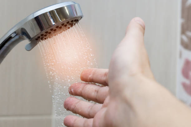 istock hand in the shower test water temperature 1139036477