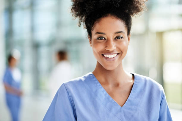 Being in this profession gives me great purpose Portrait of a young nurse standing in a hospital medical scrubs stock pictures, royalty-free photos & images