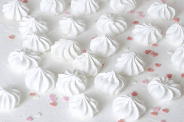 istock Heart sprinkles and little fresh baked meringues on white surface 1139037155
