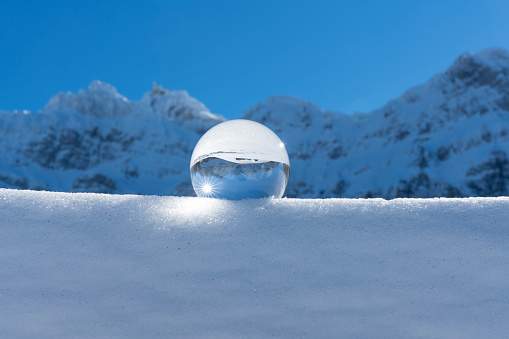 The Swiss Säntis in winter through a crystal ball
