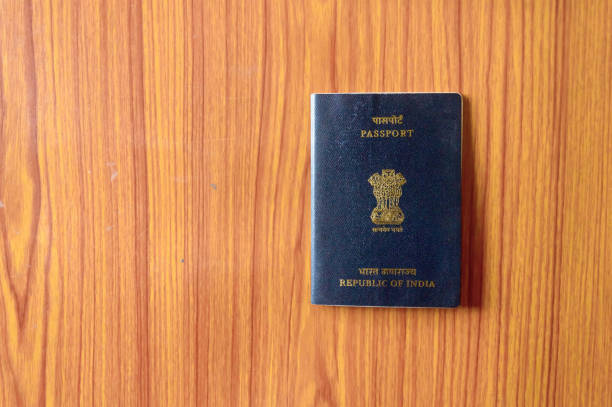 indian passport book on wooden table hardwood floor. close up. travel tourism and holiday vacation concept. mockup. top high angel view object with clipping path. flat lay. copy space room for text - passport usa american culture front view imagens e fotografias de stock