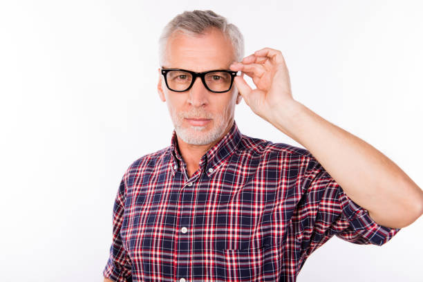 istock Confident gray aged man holding glasses with one hand 1139041917