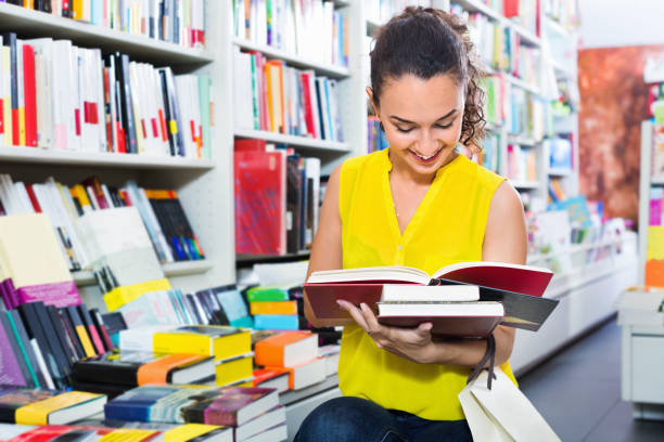 istock Woman standing with open in publishers store 1139043071