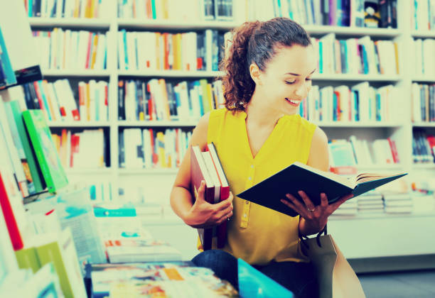 istock Woman reading textbook in shop 1139043076