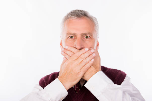 istock Handsome confident businessman with gray beard shutting mouth 1139043279
