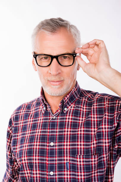 istock Confident gray aged man holding glasses with one hand 1139043765