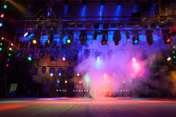 Theater light on stage Light effects on stage created with theatrical lighting equipment and a smoke machine performing arts event stock pictures, royalty-free photos & images