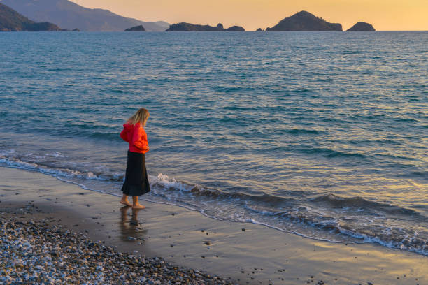 istock Woman camping at the beach. 1139045469