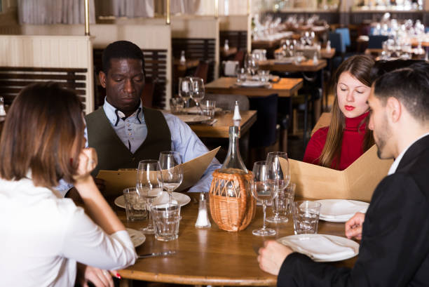 istock Group of people choosing dishes from menu 1139047210