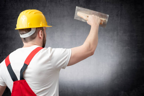 istock Rear view of a worker plastering a wall indoors 1139047578