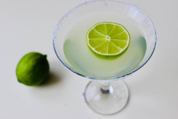 istock coctail in a martini glass and lime on white background 1139047834