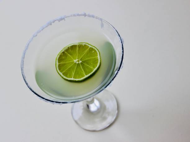 istock coctail in a martini glass and lime on white background 1139047978