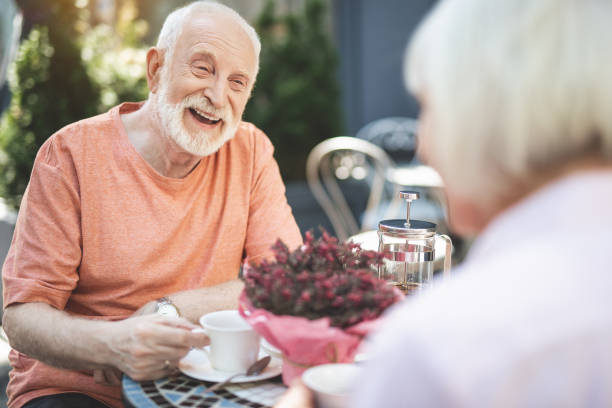 istock Happy old man talking to wife outside 1139049314