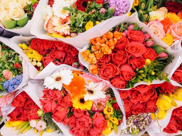 Photo of Assortment of bouquets of colorful tulips in a flower shop.