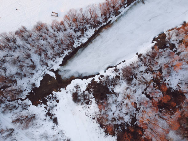 istock The forest and the frozen river with thawed patches appeared in the spring, when there is still snow in Russia from the height of the quadrocopter 1139053303