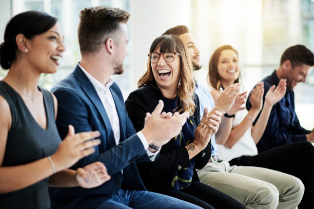 Inspire your teams to keep on achieving Shot of a group of businesspeople applauding during a seminar coworker stock pictures, royalty-free photos & images
