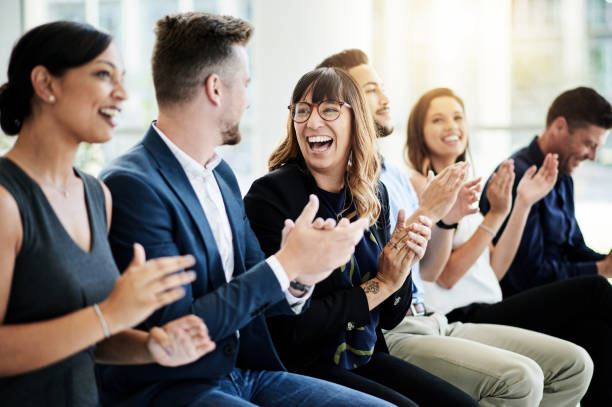 Inspire your teams to keep on achieving Shot of a group of businesspeople applauding during a seminar happy workers stock pictures, royalty-free photos & images