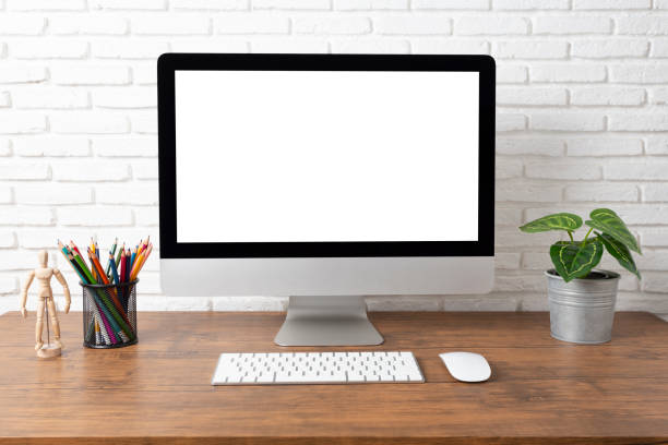 istock workspace with computer with blank white screen, and office supplies on a wooden desk 1139055012