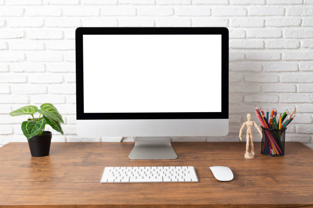 istock workspace with computer with blank white screen, and office supplies on a wooden desk 1139055016