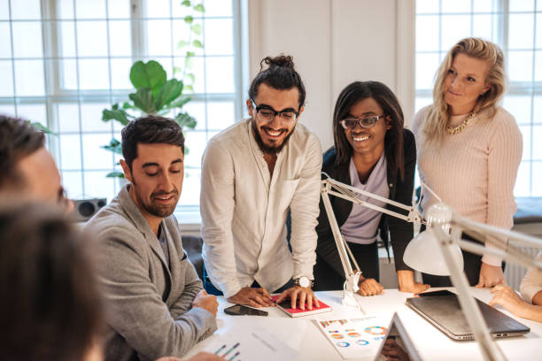 istock Mixed business team working on project discussing finances 1139057832