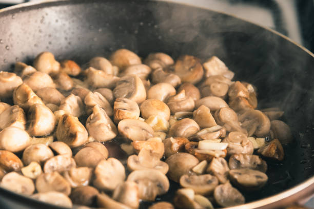 istock Champignon mushrooms are fried in a pan - close-up 1139061797