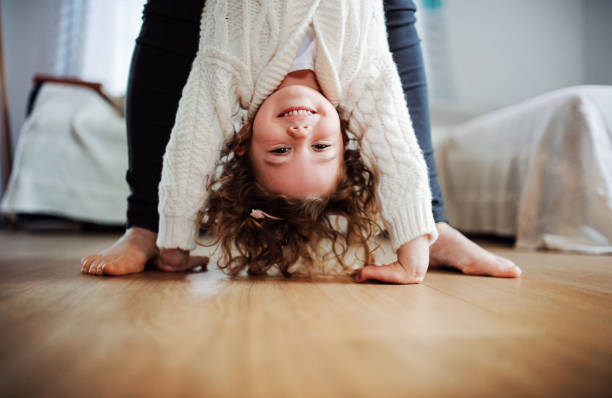 istock An unrecognizable mother holding small girl upside down at home. 1139062235