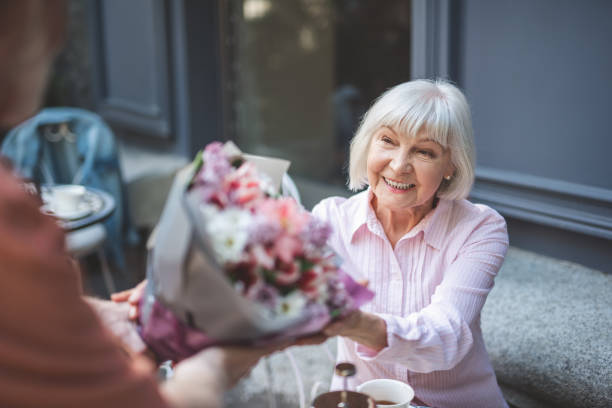 istock Happy mature woman accepting posy on date 1139063729