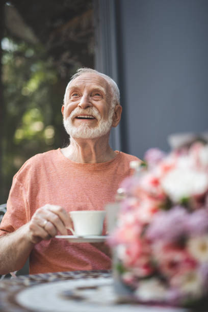 istock Happy old man drinking hot drink outdoors 1139063735