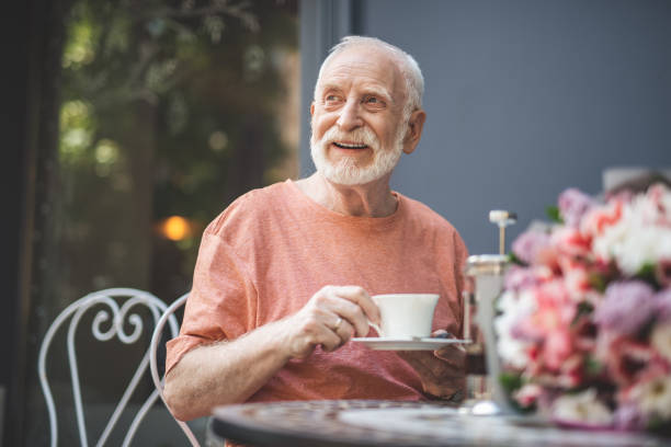istock Delighted elderly male drinking tea in expectation 1139063742
