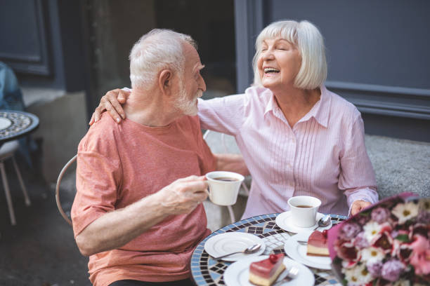 istock Loving old couple having fun in cafe 1139063756