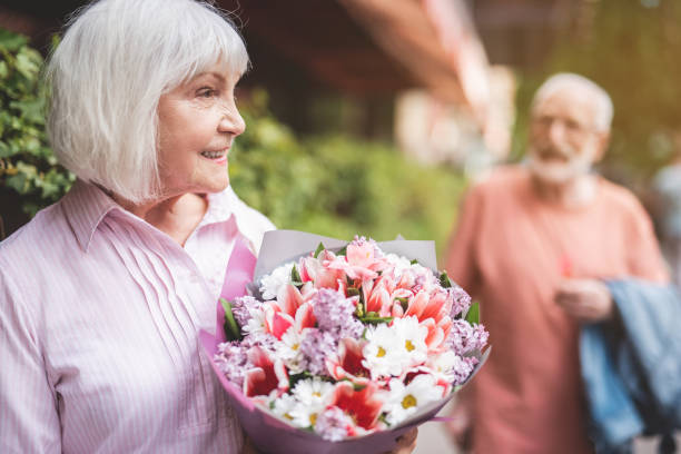 istock Delighted woman with bouquet outside 1139063784