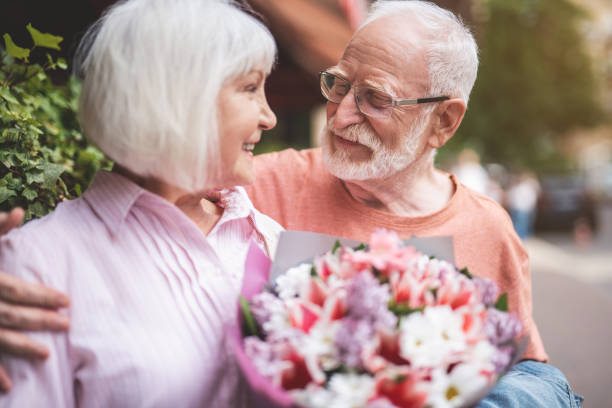 istock Happy old couple embracing outside 1139063787