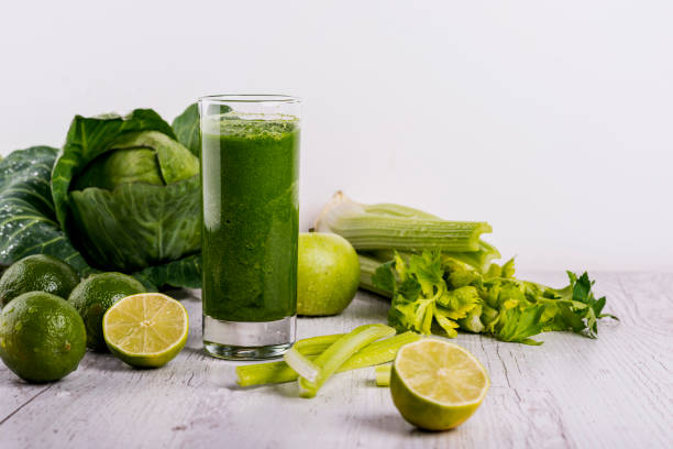 istock Healthy green smoothie with straw in a jar mug on white background. Copy space. 1139064092
