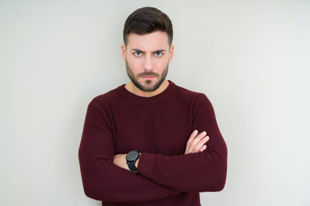 istock Young handsome man wearing a sweater over isolated background skeptic and nervous, disapproving expression on face with crossed arms. Negative person. 1139064576