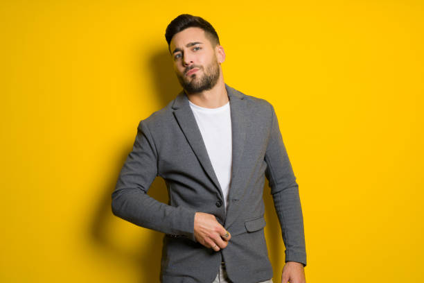 istock Young handsome man possing and modeling over yellow isolated background 1139065286