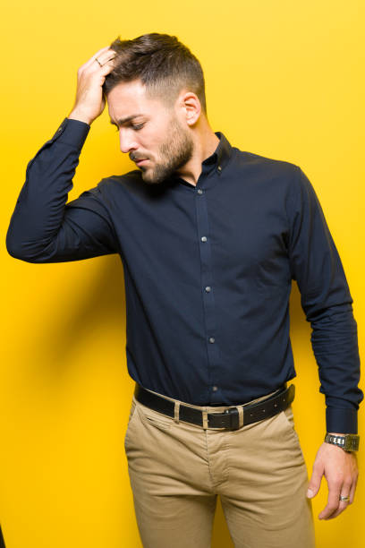 istock Young handsome man posing and modeling over yellow isolated background 1139065358